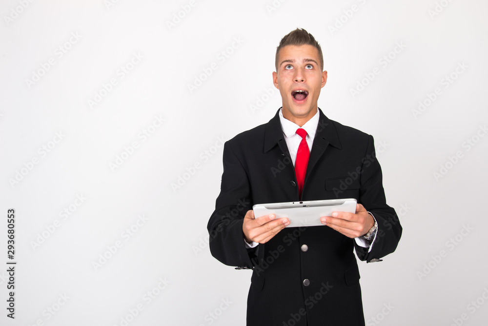 Handsome attractive smiling happy joyful young casual businessman male using tablet isolated on the white background, millennial modern working, gadget online data and information business concept