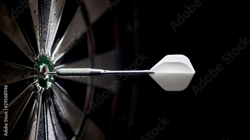 one dart in the center of a dartboard