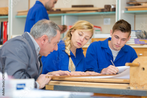 carpentry apprentice group thinking of a design photo