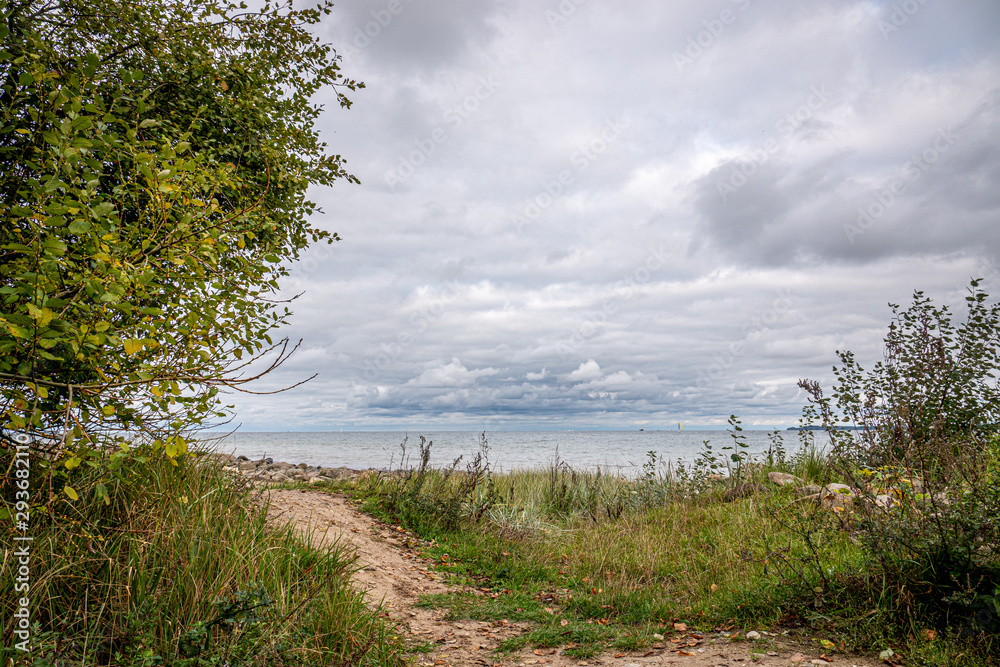 a path leads to the bay of Travemünde in cloudy autumn weather