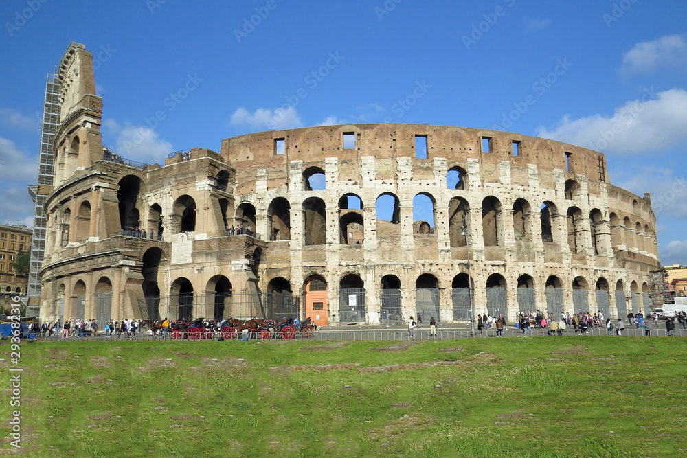 Total view of the Roman colosseum in front of blue sky in Rome, Italy, Europe
