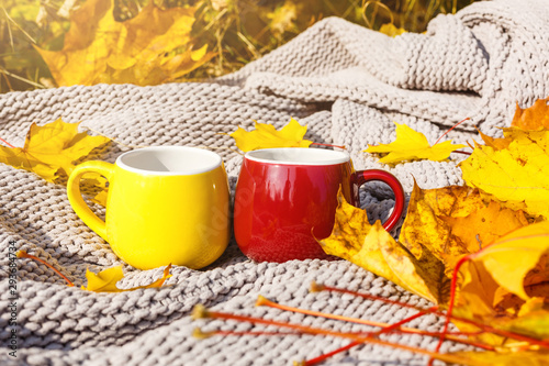 Autumn leaves and hot steaming cup of coffee. Fall season, leisure time and coffee break concept.