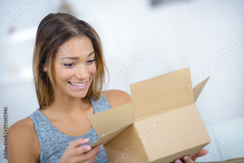 a woman is opening a box
