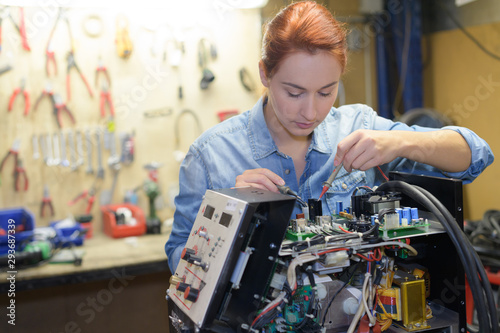 young woman in robotics class research electronic device