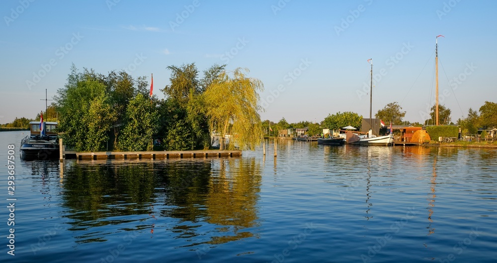 Dutch scenery with boats and trees in amsterdam