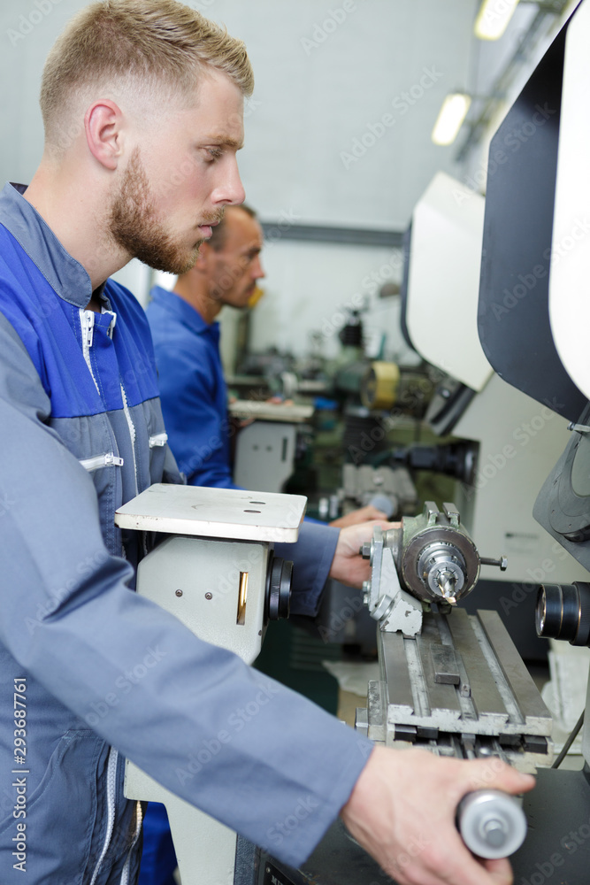 worker at a grinding machine