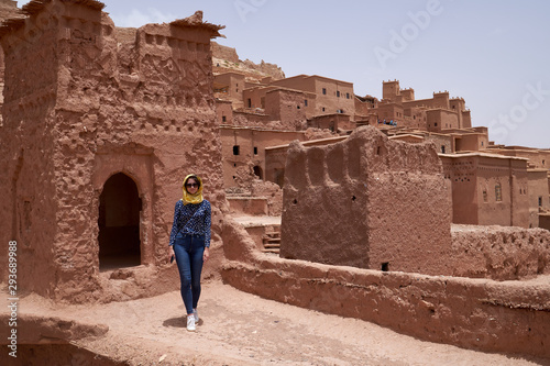 Female traveler in Kasbah, Ksar Ait Ben Haddou. It is a UNESCO World Heritage Site, a fortified city, a group of earthen buildings surrounded by walls, province of Ouarzazate, Morocco. photo