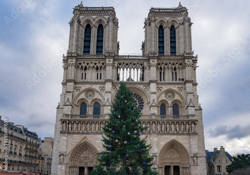 PARIS, FRANCE, December 16, 2017. Front facade of cathedral of Notre Dame de Paris, with square full of people in front, © zilber42