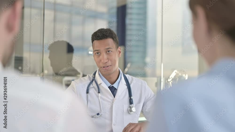 Rear Back View of Couple having talk with Young Doctor Rear Back View of Couple having talk with Young Doctor