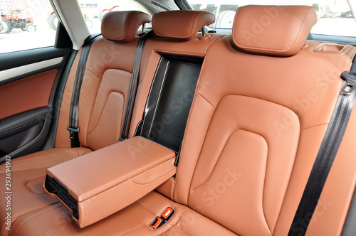 orange brown leather seat upholstery inside car © el_cigarrito