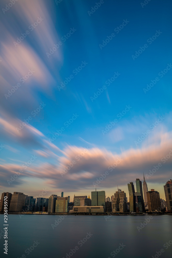 Midtown Manhattan skyline viewed from Long Island City, featuring dramatic sky over the city