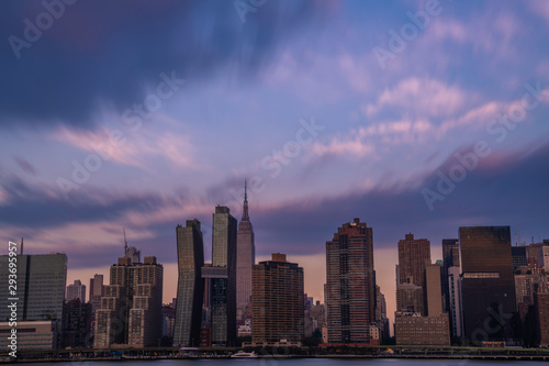 Midtown Manhattan skyline viewed from Long Island City  featuring dramatic sky over the city at sunrise