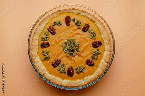 Tasty pumpkin pie, tart made for Thanksgiving day in a baking dish Top view.