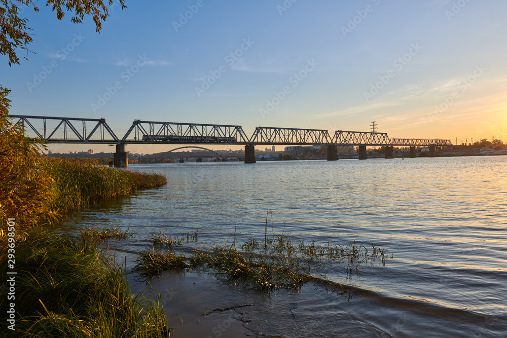 Railway bridge over the Dnieper River in Kyiv, Ukraine at sunset