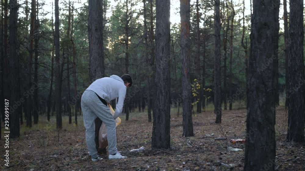 volunteer with garbage bags cleaning forest volunteer with garbage bags cleaning forest