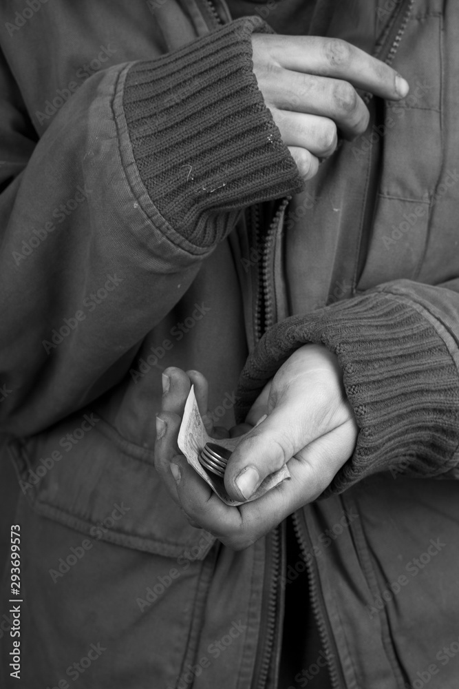 the beggar in a jacket froze and asks for cash help,concept: loneliness and poverty