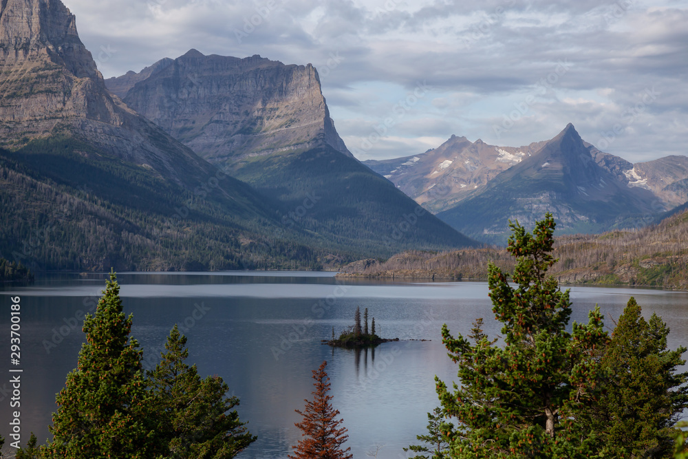 Beautiful View of a Glacier Lake with American Rocky Mountain Landscape in the background during a Cloudy Summer Morning. Taken in Glacier National Park, Montana, United States.