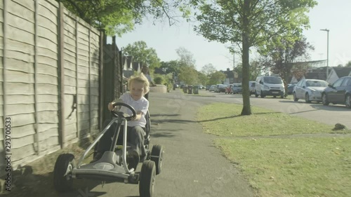 Front view of a pre teen caucasian boy on pedal kart
