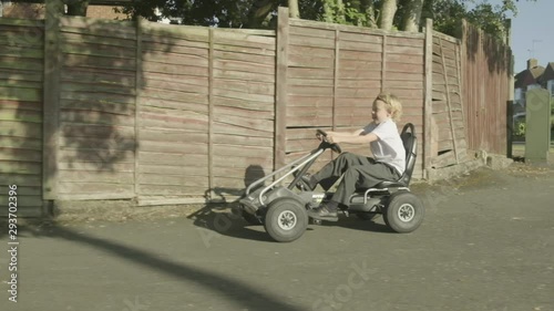 Front view of a pre teen caucasian boy on pedal kart