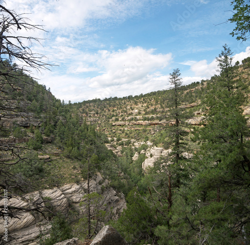 Cliff Dwellings carved in rock on Walnut Canyon stone wall, Arizona photo