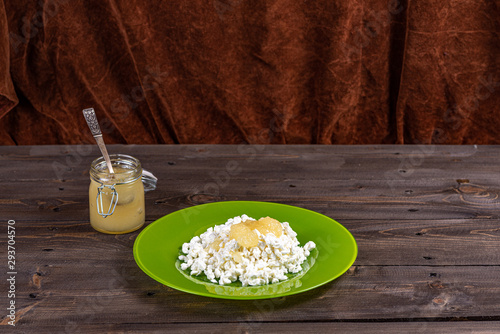 Tender low-fat cottage cheese with honey on a plate