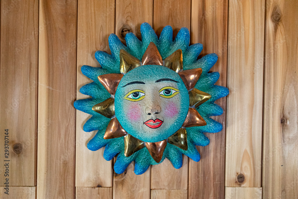 Symbolic & cultural sun face wall art. A closeup view of an ornamental