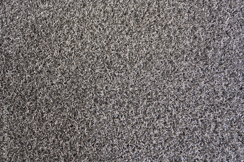 The floor mat is made of plastic PVC mixed with synthetic rubber. Soft, sponge-like texture with a dark gray color. The floor mat is made of plastic PVC mixed with synthetic rubber. Soft, sponge-like texture with a dark gray color.