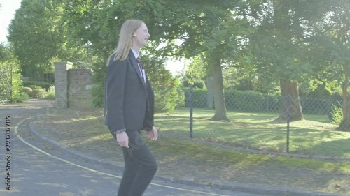 Senior school girl walking to school themes of education routines childhood