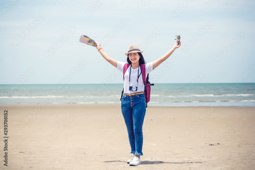 Traveling people concept. Young happy asian gril at the beach Traveling people concept. Young happy asian gril at the beach