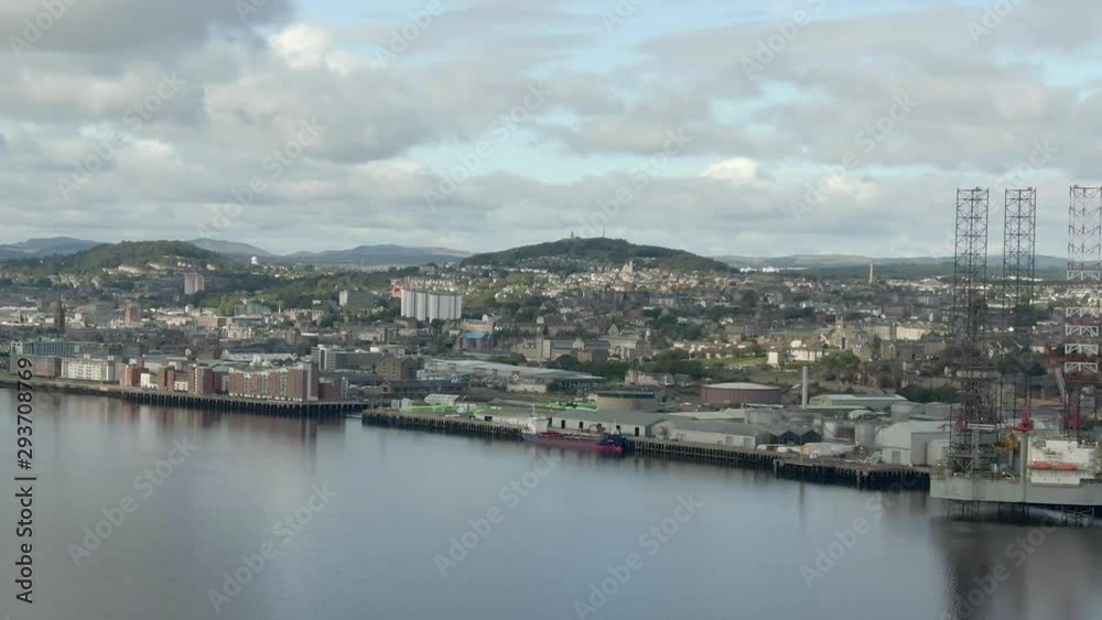 An aerial view of Dundee city on a cloudy day. Tracking left to right across the city from across the estuary. An aerial view of Dundee city on a cloudy day. Tracking left to right across the city from across the estuary.