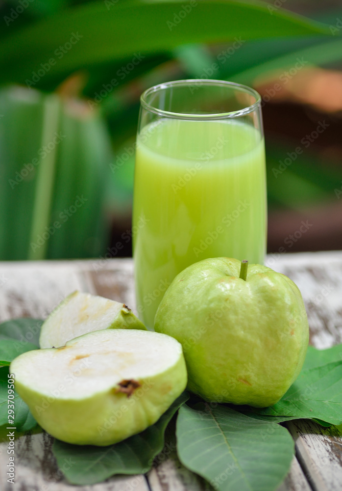 Guava juice and fresh Guava on wooden background Guava juice and fresh Guava on wooden background