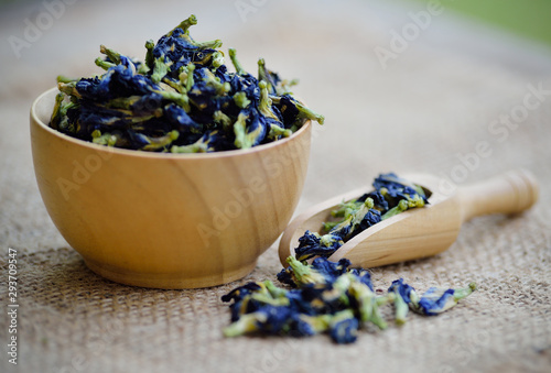 dried butterfly pea flowers on wooden background