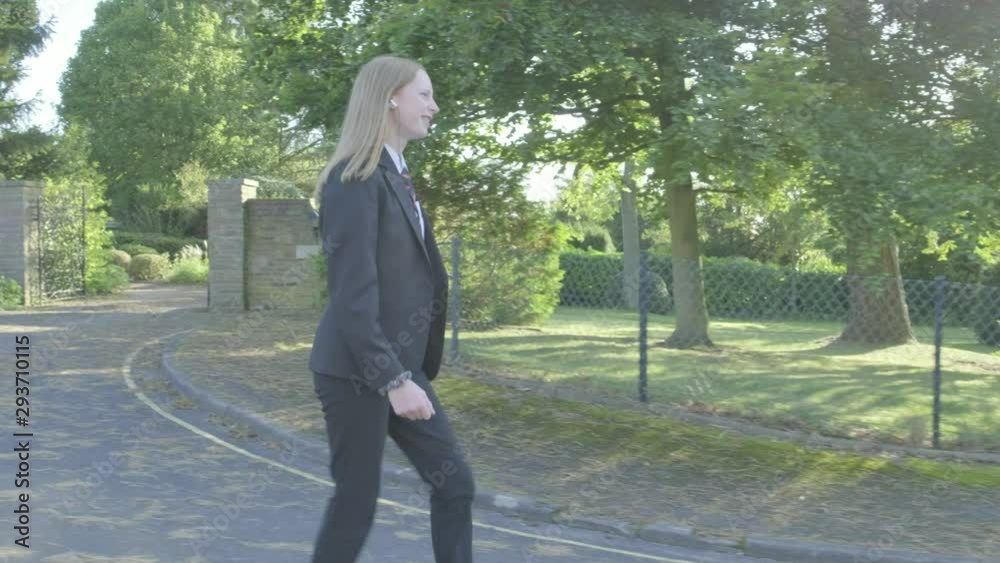 Senior school girl walking to school themes of education routines childhood Senior school girl walking to school themes of education routines childhood