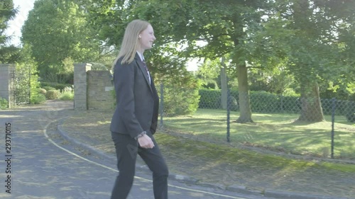Senior school girl walking to school themes of education routines childhood
