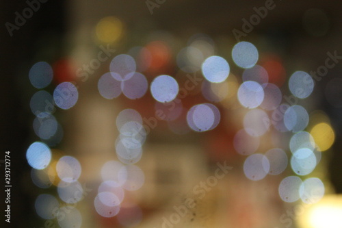 Blurred image of decorative bulbs light during festival such as Christmas and New Year. Beautiful bokeh for wallpaper of background. Defocus and out of focus. photo