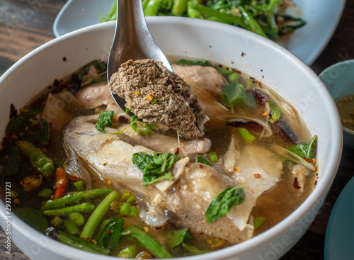 Tom Yum grouper fish head or Sour fish soup in the hot pot photo