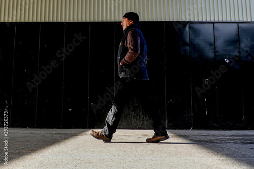 Canvas Print Stockholm, Sweden A man walks through strong shadows of the Varberg Centrum inthe suburbs