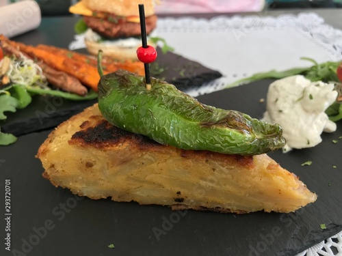 Grilled green pepper with vegan potato omelette. Delicious healthy vegan vegetarian food in Sotogrande Andalucia Spain. Lunch menu that plays in all colors and is good for your health. photo