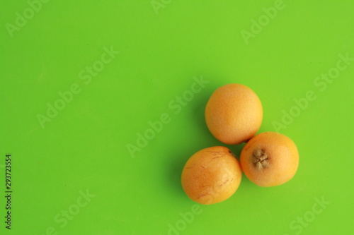 delicious yellow medlar fruit with colorful background photo