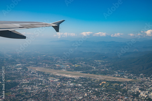 Chiang Mai International Airport and surrounding area with clear blue sky view from airplane window