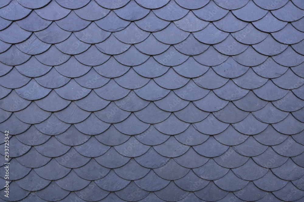 Aged slate roof tiles close-up Aged slate roof tiles close-up