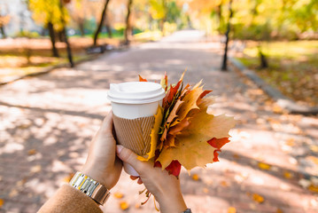woman holding coffee cup drink to go autumn fall season