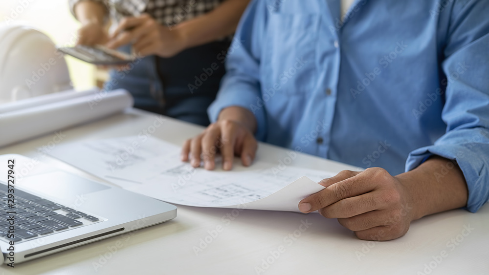 Engineer or architect teamwork working on construction project with building model and blueprint in office. Construction concept. Engineer or architect teamwork working on construction project with building model and blueprint in office. Construction concept.