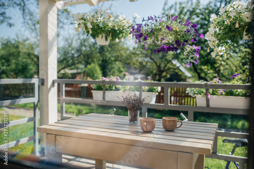 Summer cozy porch with flowers and coffee