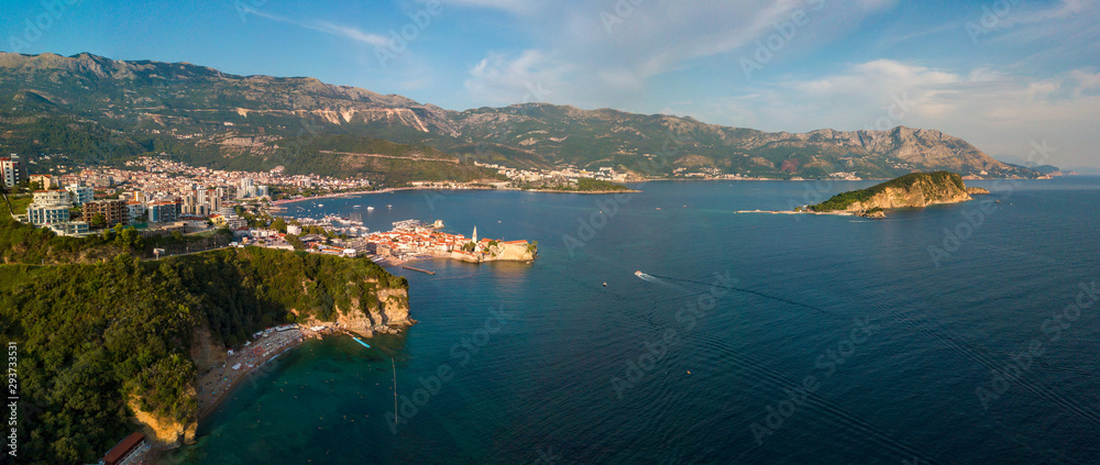 Aerial view of Mogren beach (two sandy beaches) and the old city (stari grad) of Budva, and Sveti Nikola island. Montenegro. Jagged coast on the Adriatic Sea