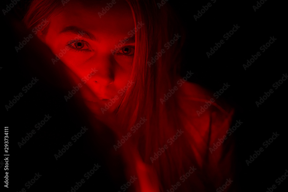 Woman laying on car covered with red light. Woman laying on car covered with red light.