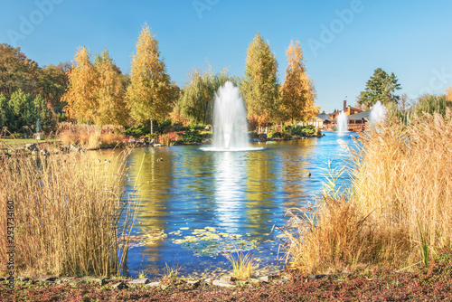  Fragment of the park in Mezhyhiria near Kiev, fountains on the lake. Scenery of nature with sunlight. photo