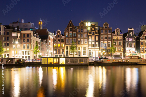 building architecture along canal against reflection of light night 