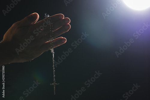 Hands holding holy necklace on full moon