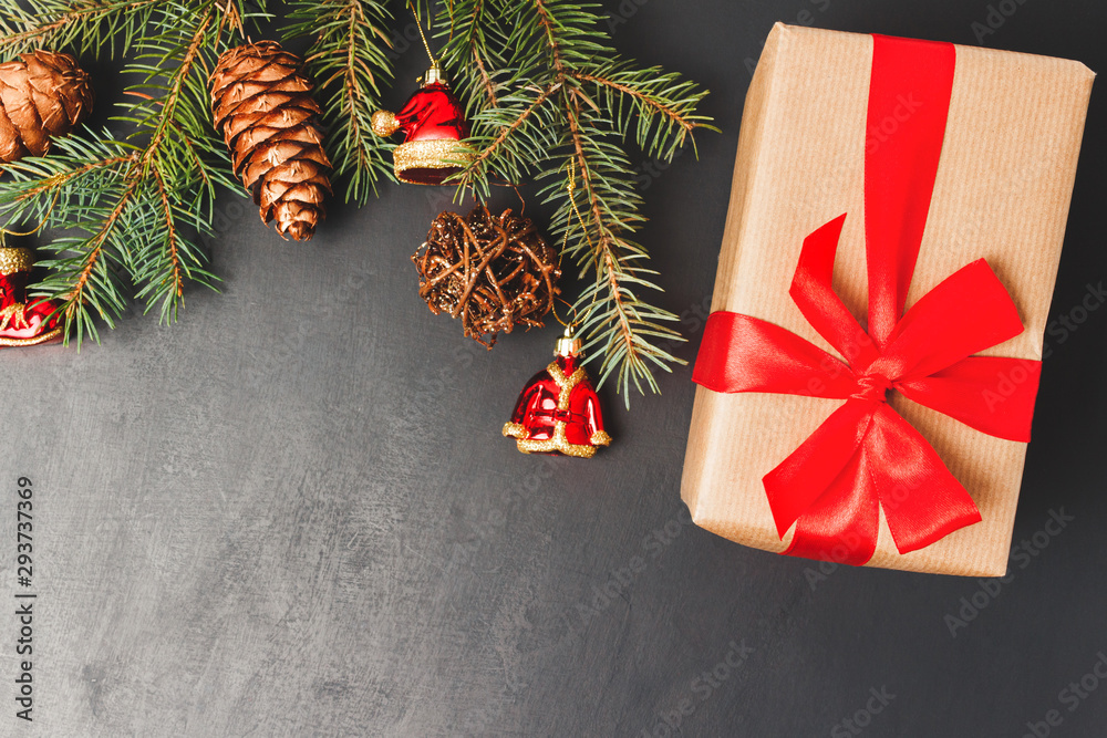 Christmas or New Year background with decorations, pine branch and gift box, top view with copy space Christmas or New Year background with decorations, pine branch and gift box, top view with copy space